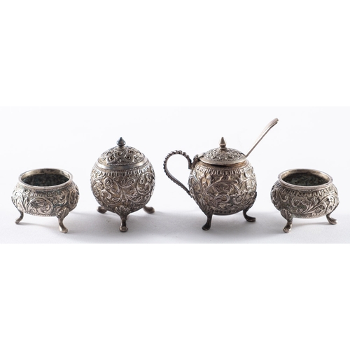 296 - An Indian white metal four piece cruet set.