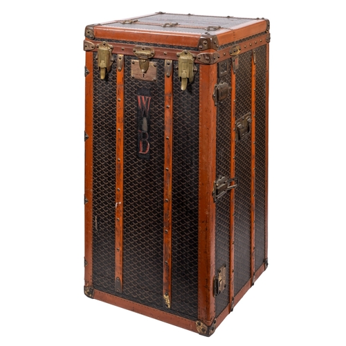 317 - MALLES GOYARD.. A canvas, leather bound and brass mounted steamer trunk with hinged top and front en... 