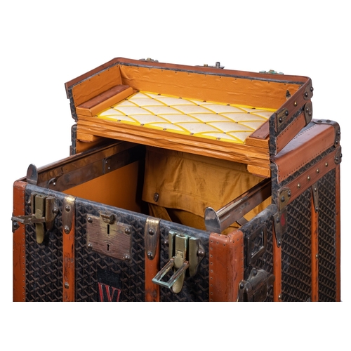 317 - MALLES GOYARD.. A canvas, leather bound and brass mounted steamer trunk with hinged top and front en... 