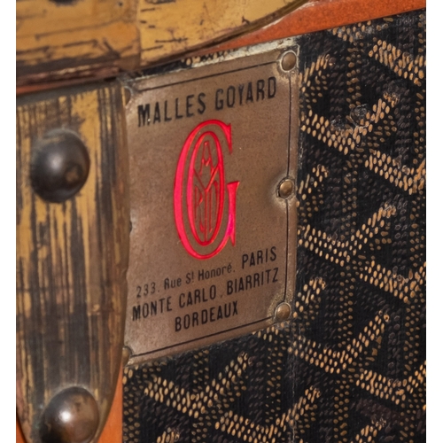 317 - MALLES GOYARD.. A canvas, leather bound and brass mounted steamer trunk with hinged top and front en... 