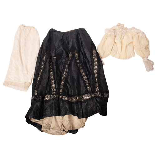 332 - An Edwardian black silk and lace skirt, together with a white cotton and lacework blouse, a yellow c... 