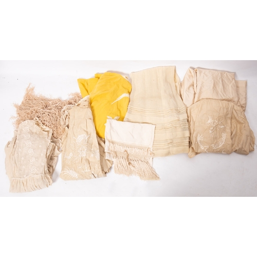 332 - An Edwardian black silk and lace skirt, together with a white cotton and lacework blouse, a yellow c... 