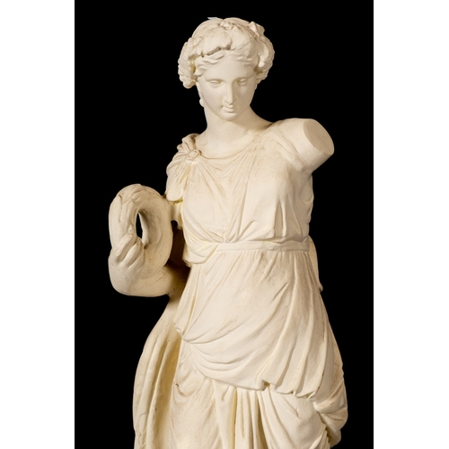 338 - A plaster model of a maiden in Classical style, late 19th/early 20th Century; the standing figure ho... 