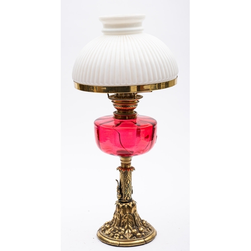 352 - A late Victorian brass oil lamp with reeded opaque white glass shade and cranberry glass circular oi... 