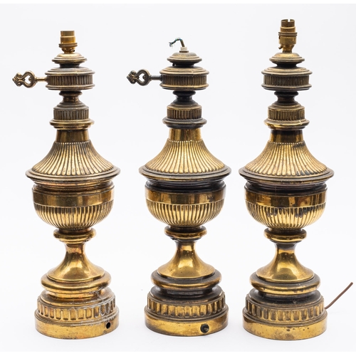 353 - A set of three late Victorian brass electric table lamps, in the form of oil lamps with reeded decor... 