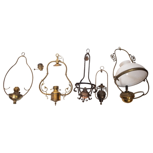 358 - A collection of five late Victorian/ Edwardian hanging oil lamps, with shaped uprights and circular ... 