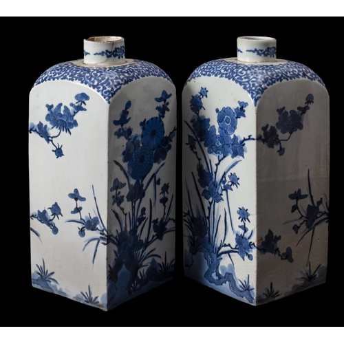 404 - A pair of Japanese Arita blue and white square-section bottles (tokkuri), circa 1700, decorated with... 