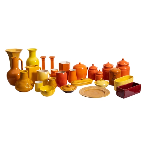 435 - A collection of brightly coloured orange and yellow glazed ceramicwares including a pair of candlest... 