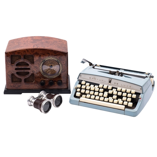 444 - A Brother Deluxe typewriter together with a pair of opera glasses and a simulated bakelite radio.