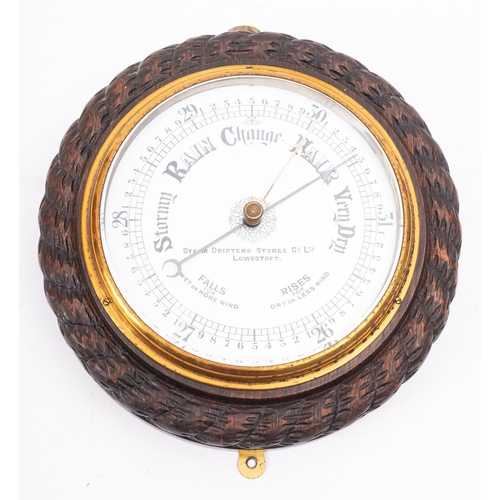 161A - An Edwardian carved oak aneroid barometer for the 'Steam Drifters Stores Co, Ltd. Lowerstoft'  the e... 