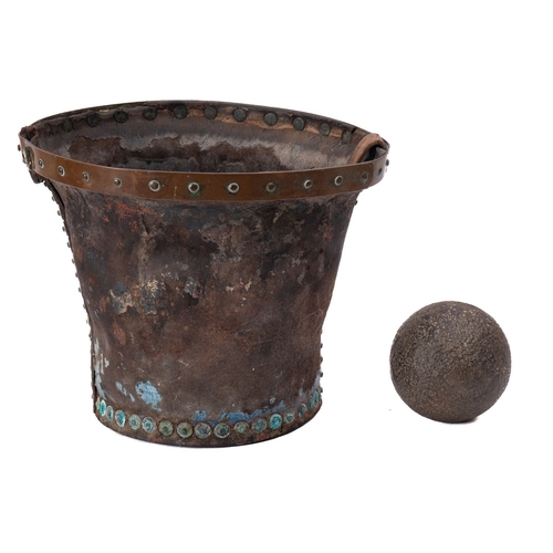 177 - A brass bound leather fire bucket, together with an 8lb cannon ball (2)