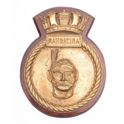 214 - A ship's bronze badge for the Royal Navy vessel HMS 'Rangatira' mounted on a mahogany plinth, 25cm h... 