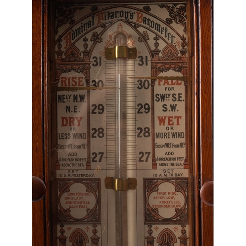 255 - An Edwardian oak Admiral Fitzroy barometer,  the arched scroll carved case enclosing  lithograph pri... 