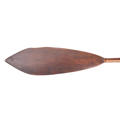 295 - A late 19th/early 20th century Maori paddle, the plain broad leaf shaped blade, with tapering shaft,... 