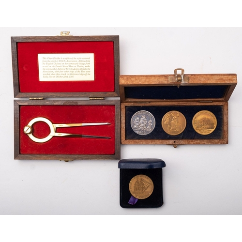 32 - A group of three reproduction Nelson Commemorative medallions in a mahogany case, together with a br... 