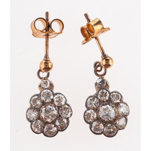 375 - A pair of antique diamond drop earrings, each set with nine old-cut diamonds in the form of a flower... 