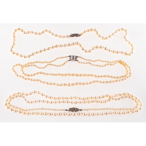 381 - A group of three pearl necklaces, including a long strand of graduated cultured pearls approx.  4mm ... 