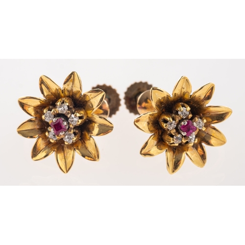 392 - A pair of flowerhead screw back earrings, each set  with a table-cut ruby, surrounded by five old-cu... 