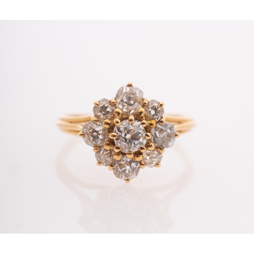 828 - Garrard. An 18ct yellow gold diamond cluster ring, claw set with nine old-cut diamonds, diamonds app... 