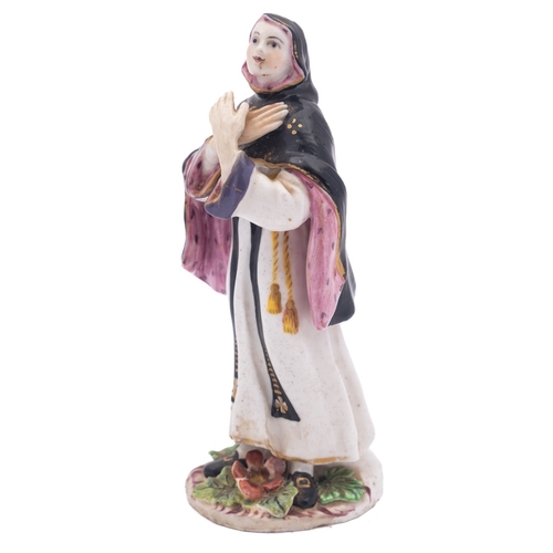 106 - A Bow figure of a nun modelled standing with hands crossed and wearing habit and veil, the base appl... 