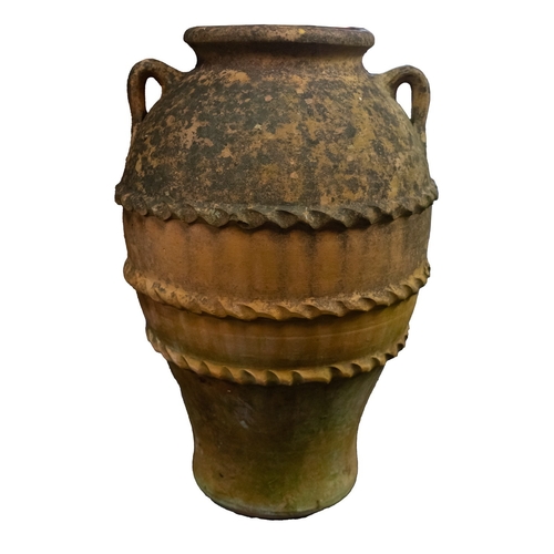 1112 - A terracotta garden urn, 20th century; of ovoid form, with everted rim above twin loop handles at th... 