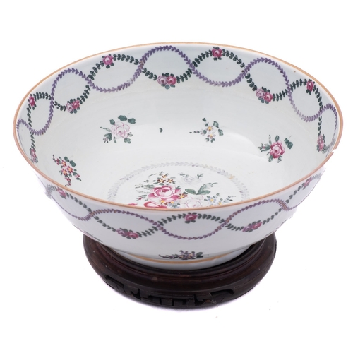 146 - A French porcelain punch bowl in Chinese export style painted with floral garlands and sprays, 28cm ... 