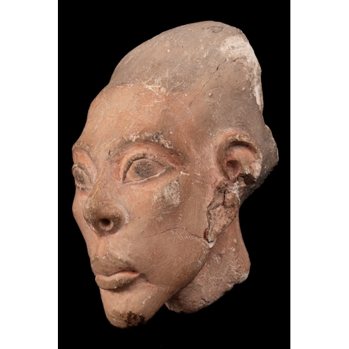 173 - An Egyptian sculpted alabaster head, probably later second millennium B.C.; the painted surfaces pro... 