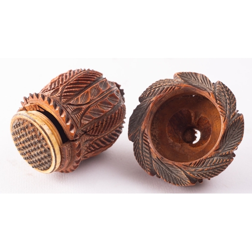 178 - A carved treen, probably coquilla nut nutmeg grater, 19th century; the domed top carved with foliage... 