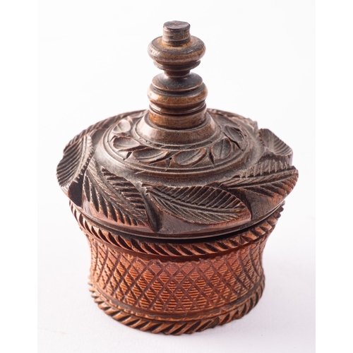 178 - A carved treen, probably coquilla nut nutmeg grater, 19th century; the domed top carved with foliage... 