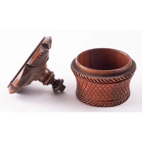 178 - A carved treen, probably coquilla nut nutmeg grater, 19th century; the domed top carved with foliage... 