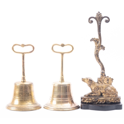 195 - A pair of Victorian brass door porters modelled as half bells, late 19th century; with loop handles ... 