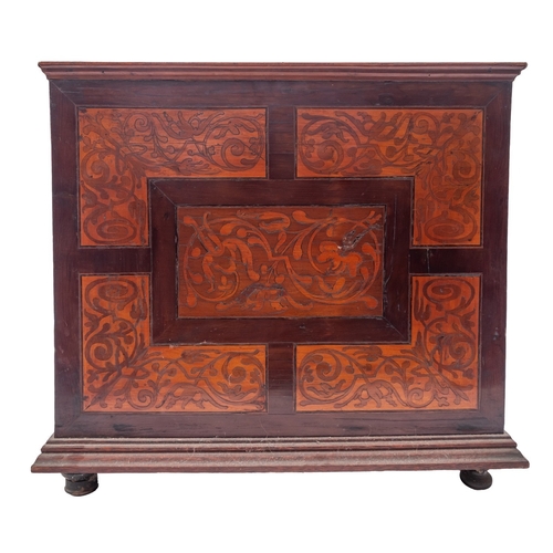 200 - A Dutch walnut and marquetry table cabinet, circa 1700;  the top with trailing foliage within a cart... 