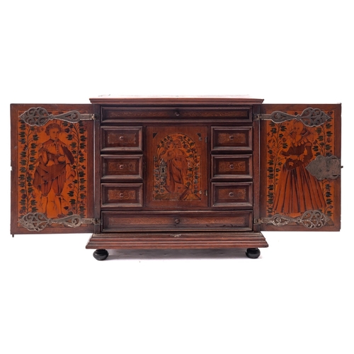 200 - A Dutch walnut and marquetry table cabinet, circa 1700;  the top with trailing foliage within a cart... 