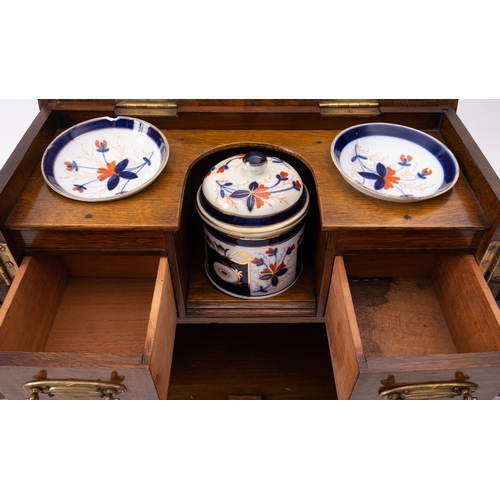 206 - An Edwardian oak and brass mounted smoker's cabinet, early 20th century; the hinged top with moulded... 