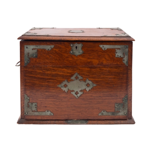 223 - An Edwardian oak and metal mounted smoker's cabinet, early 20th century; the hinged rectangular cove... 