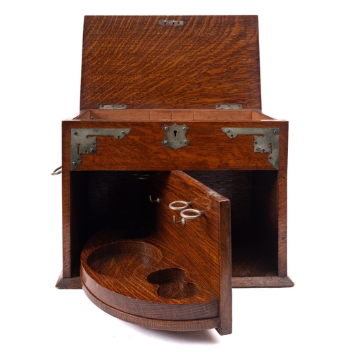 223 - An Edwardian oak and metal mounted smoker's cabinet, early 20th century; the hinged rectangular cove... 