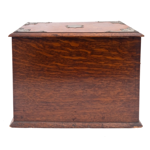 223 - An Edwardian oak and metal mounted smoker's cabinet, early 20th century; the hinged rectangular cove... 