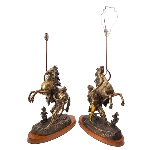 259 - A pair of Continental patinated bronze models of the Marly Horses, late 19th century and later fitte... 