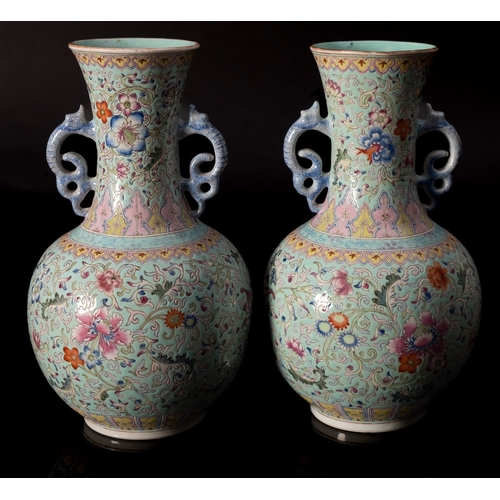 26 - A pair of Chinese famille rose baluster vases with dragon handles, painted with lotus, peony, other ... 