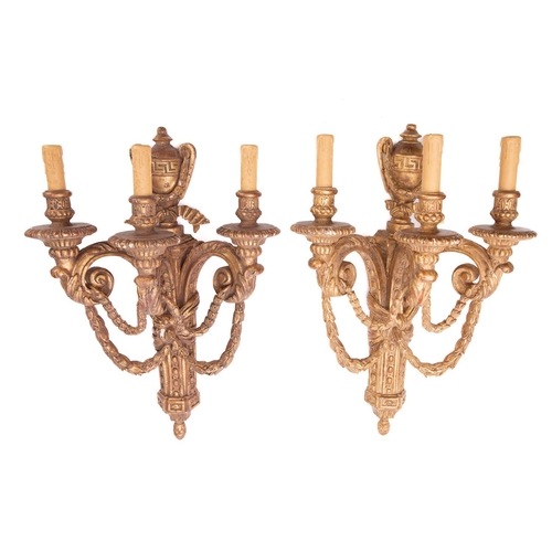 292 - A set of four carved and giltwood three light wall appliques in Louis XVI style, 20th century; the e... 