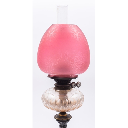 302 - A George IV or William IV bronze table oil lamp, circa 1830; with later ruby glass ovoid shade and g... 