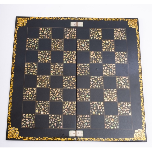 324 - A Victorian lacquered papier mache hinged chess or draughts board, mid 19th century; with parcel gil... 