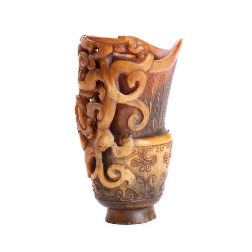 332 - A Chinese archaistic carved buffalo horn libation cup with relief carved chilong handle, the body wi... 