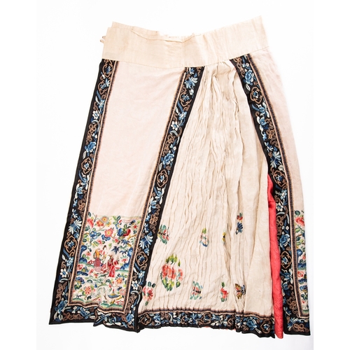 353 - A Chinese cream silk pleated skirt embroidered with butterflies, flower sprays and figures within ga... 