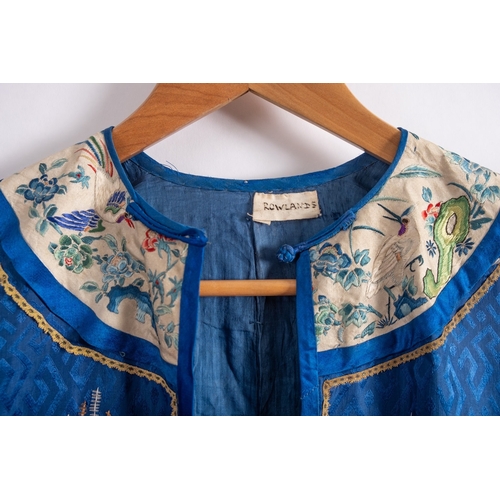 356A - A Chinese silk blue-ground robe and a pair of slippers embroidered overall with pavilions, birds, fl... 