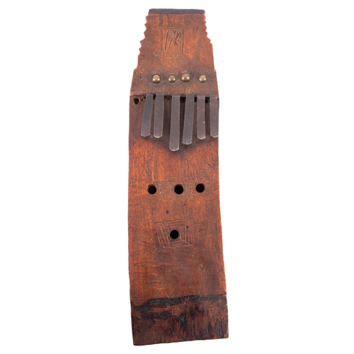 400 - An unusual antique African curved wood kalimbra, with six metal keys, 29cm x 8cm.

Provenance:  The ... 