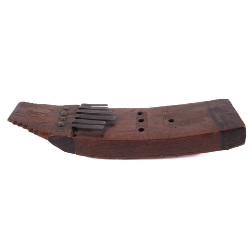 400 - An unusual antique African curved wood kalimbra, with six metal keys, 29cm x 8cm.

Provenance:  The ... 