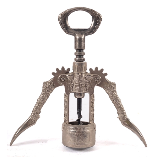 423 - An Italian double lever corkscrew, with vine pattern decoration, the centre in the form of a well.  ... 