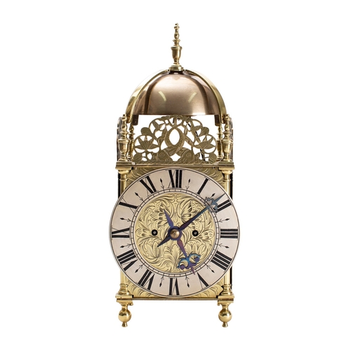 498 - An English brass lantern mantel clock the eight-day duration, double fusee movement striking the tin... 