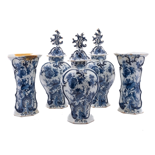 51 - A garniture of five Dutch [Het Bijltje] blue and white delftware vases and three covers, painted wit... 